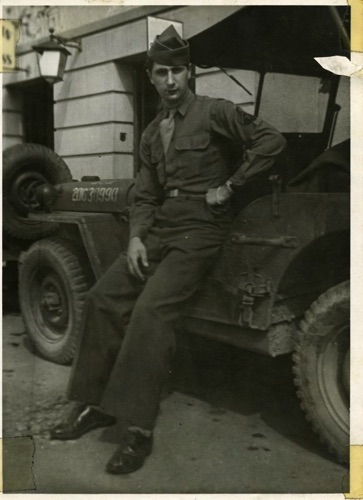 WWII John Fratto leaning against Jeep, 
4th Armored Division, Tank Battalion, German. Circa 1945. chs-007905